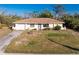 Charming single story home featuring a concrete driveway, minimalist landscaping, and neutral color palette at 7522 Sea Mist Dr, Port Charlotte, FL 33981