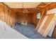 Unfinished garage with exposed wood framework, plywood sheets, and concrete floor at 7522 Sea Mist Dr, Port Charlotte, FL 33981