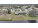 Overhead view of the backyard showing the screen enclosed pool and waterfront at 8 Broadmoor Ln, Rotonda West, FL 33947