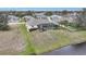 A high angle view of the screen enclosed pool and waterfront backyard of the home at 8 Broadmoor Ln, Rotonda West, FL 33947