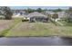 Aerial view of the home, showcasing the pool, screen enclosure, and waterfront backyard at 8 Broadmoor Ln, Rotonda West, FL 33947