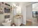 Bathroom offering a decorative toilet area and vanity with granite counters and white cabinets at 8 Broadmoor Ln, Rotonda West, FL 33947