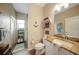 Bathroom featuring a granite-topped vanity, wood-look flooring, and a shower in the background at 8 Broadmoor Ln, Rotonda West, FL 33947