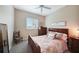 Comfortable bedroom featuring a bed with decorative pillows, a dresser, and a chair in the corner at 8 Broadmoor Ln, Rotonda West, FL 33947