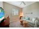 Cozy bedroom with comfortable seating area featuring a striped sofa and a beachy aesthetic at 8 Broadmoor Ln, Rotonda West, FL 33947