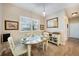 Cozy dining area with plantation shutters, an oval table, and views to the kitchen at 8 Broadmoor Ln, Rotonda West, FL 33947