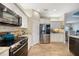 Modern kitchen featuring stainless steel appliances, granite countertops and a mosaic backsplash at 8 Broadmoor Ln, Rotonda West, FL 33947