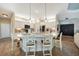 Bright kitchen island with white cabinets, granite countertops and bar seating, perfect for entertaining guests at 8 Broadmoor Ln, Rotonda West, FL 33947