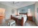 Spacious main bedroom featuring a decorative headboard, accent wall and light-toned hardwood flooring at 8 Broadmoor Ln, Rotonda West, FL 33947