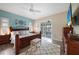 Serene main bedroom with blue accent wall, wood floors, sliding glass doors to lanai and neutral furnishings at 8 Broadmoor Ln, Rotonda West, FL 33947