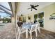 Outdoor dining and seating space with a ceiling fan and sliding glass doors at 8 Broadmoor Ln, Rotonda West, FL 33947