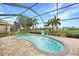 Inviting screened-in pool area with lush landscaping and an outdoor basketball hoop at 8 Broadmoor Ln, Rotonda West, FL 33947