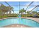 Sparkling pool in a screened enclosure, complete with patio and grilling area at 8 Broadmoor Ln, Rotonda West, FL 33947