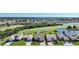 Aerial view of community, golf course, and water features at 8377 Parkside Dr, Englewood, FL 34224