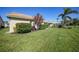 Well-manicured backyard with lush lawn and beautiful landscaping at 8377 Parkside Dr, Englewood, FL 34224