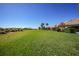 Large grassy backyard with partial view of neighboring homes at 8377 Parkside Dr, Englewood, FL 34224