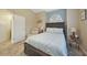 Well-lit bedroom with a queen bed and neutral color palette at 8377 Parkside Dr, Englewood, FL 34224