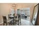 Dining area with sliding doors that open to a relaxing sunroom at 8377 Parkside Dr, Englewood, FL 34224