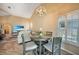 Casual dining area with table and chairs near a window with plantation shutters at 8377 Parkside Dr, Englewood, FL 34224