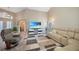 Spacious living area with a sectional sofa, recliner, and hardwood floors at 8377 Parkside Dr, Englewood, FL 34224