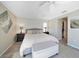 Spacious main bedroom with king-size bed and access to a private balcony at 8377 Parkside Dr, Englewood, FL 34224