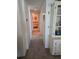 Long hallway with carpeted floors and access to bedrooms at 8479 Tanaka Dr, Englewood, FL 34224