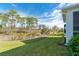 Large backyard with grassy area and natural landscape at 8960 Scallop Way, Placida, FL 33946