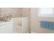 Walk-in bathtub with tiled surround and window at 8960 Scallop Way, Placida, FL 33946