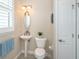 Small bathroom with pedestal sink, toilet, and linen closet at 8960 Scallop Way, Placida, FL 33946