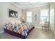 King-size bed, colorful quilt, and large window with shutters at 8960 Scallop Way, Placida, FL 33946