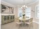 Well-lit dining area with a round table and chairs, featuring coastal artwork at 8960 Scallop Way, Placida, FL 33946