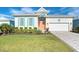 Coastal-style home with light-colored siding and a gray paver driveway at 8960 Scallop Way, Placida, FL 33946