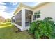 Well-maintained exterior with a screened lanai and lush landscaping at 8960 Scallop Way, Placida, FL 33946