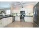 Bright kitchen featuring stainless steel appliances and white cabinets at 8960 Scallop Way, Placida, FL 33946