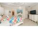 Main bedroom with king bed, ensuite bathroom access, and TV at 8960 Scallop Way, Placida, FL 33946