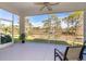 Spacious screened lanai with comfortable seating and a ceiling fan at 8960 Scallop Way, Placida, FL 33946