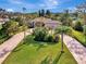 An aerial view of a house with a large, manicured lawn and palm trees at 910 Park Place Dr, Englewood, FL 34223