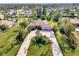 Aerial view showcasing a single-Gathering home with a circular driveway and palm trees at 910 Park Place Dr, Englewood, FL 34223