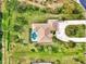 Bird's eye view of house, pool, and expansive lot at 910 Park Place Dr, Englewood, FL 34223