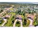 Aerial view of three houses with lush landscaping and circular driveways at 910 Park Place Dr, Englewood, FL 34223