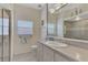 Bathroom features a vanity, toilet, and large mirror at 910 Park Place Dr, Englewood, FL 34223