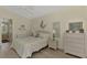 Comfortable bedroom with wicker furniture and en-suite bathroom at 910 Park Place Dr, Englewood, FL 34223