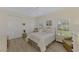 Well-lit bedroom with a queen bed and backyard view at 910 Park Place Dr, Englewood, FL 34223