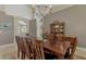 Bright dining room, hardwood table with seating for eight at 910 Park Place Dr, Englewood, FL 34223