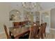 Elegant dining room with a dark wood table and chandelier at 910 Park Place Dr, Englewood, FL 34223