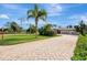 Brick driveway and landscaping leading to house at 910 Park Place Dr, Englewood, FL 34223