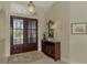 Bright entryway features a decorative mirror and console table at 910 Park Place Dr, Englewood, FL 34223