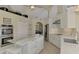 White kitchen with large island, stainless steel appliances, and view to dining area at 910 Park Place Dr, Englewood, FL 34223