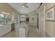 Bright kitchen with white cabinets, island, and stainless steel appliances at 910 Park Place Dr, Englewood, FL 34223