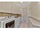 Bright laundry room, washer, dryer, and ample storage at 910 Park Place Dr, Englewood, FL 34223